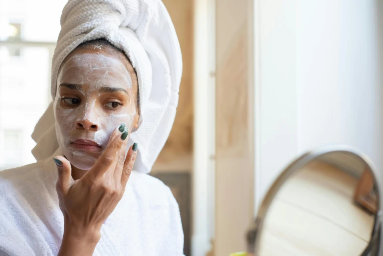 a woman with a towel on her head shaving her face, a portrait, trending on pexels, renaissance, manuka, thumbnail, square facial structure, face mask