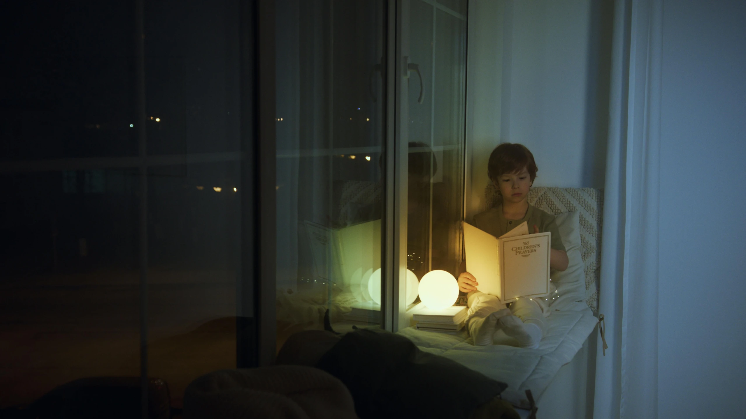 a woman sitting on a bed reading a book, inspired by Elsa Bleda, illuminated orbs, indoor lighting, alessio albi, small in size