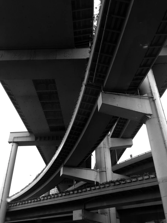 a black and white photo of a bridge, by Yasushi Sugiyama, brutalism, freeway, 2022 photograph, low angle!!!!, in tokio