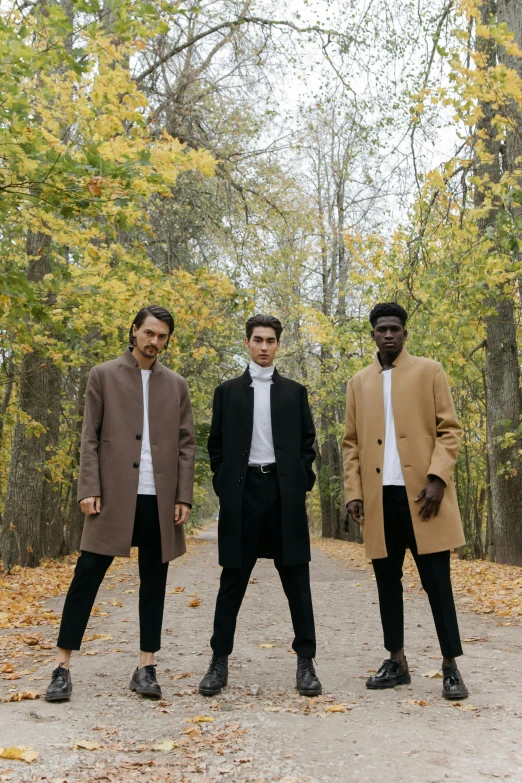 a group of men standing next to each other on a dirt road, an album cover, by Sebastian Vrancx, pexels contest winner, antipodeans, wearing a long coat, leafs, brown skin, 3-piece-suit