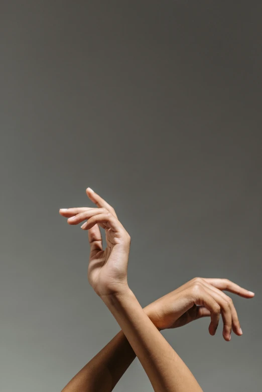 a woman reaching up to catch a frisbee, an album cover, by James Morris, trending on pexels, arabesque, hands anatomy, ballet style pose, close-up of thin soft hand, studio photo