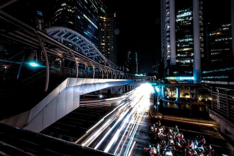 a city street filled with lots of traffic next to tall buildings, by Sebastian Vrancx, pexels contest winner, light trail, bangkok, cyberpunk elevated train, lunar busy street