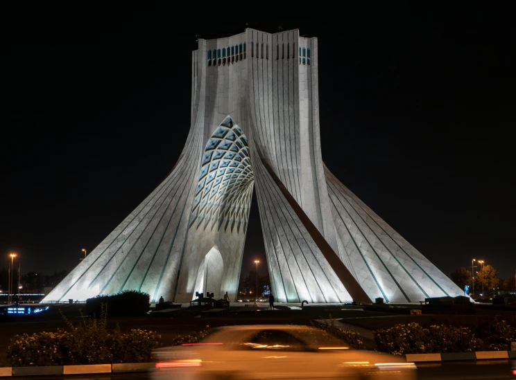 a very tall building that is lit up at night, a marble sculpture, inspired by Zaha Hadid, pexels contest winner, renaissance, iran, 7 0 s photo, white sweeping arches, sayem reza