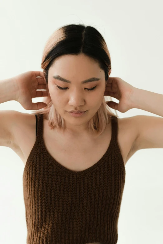 a woman standing in front of a plate of food, inspired by Ren Hang, trending on pexels, renaissance, face muscles, ears are listening, wearing tanktop, brown