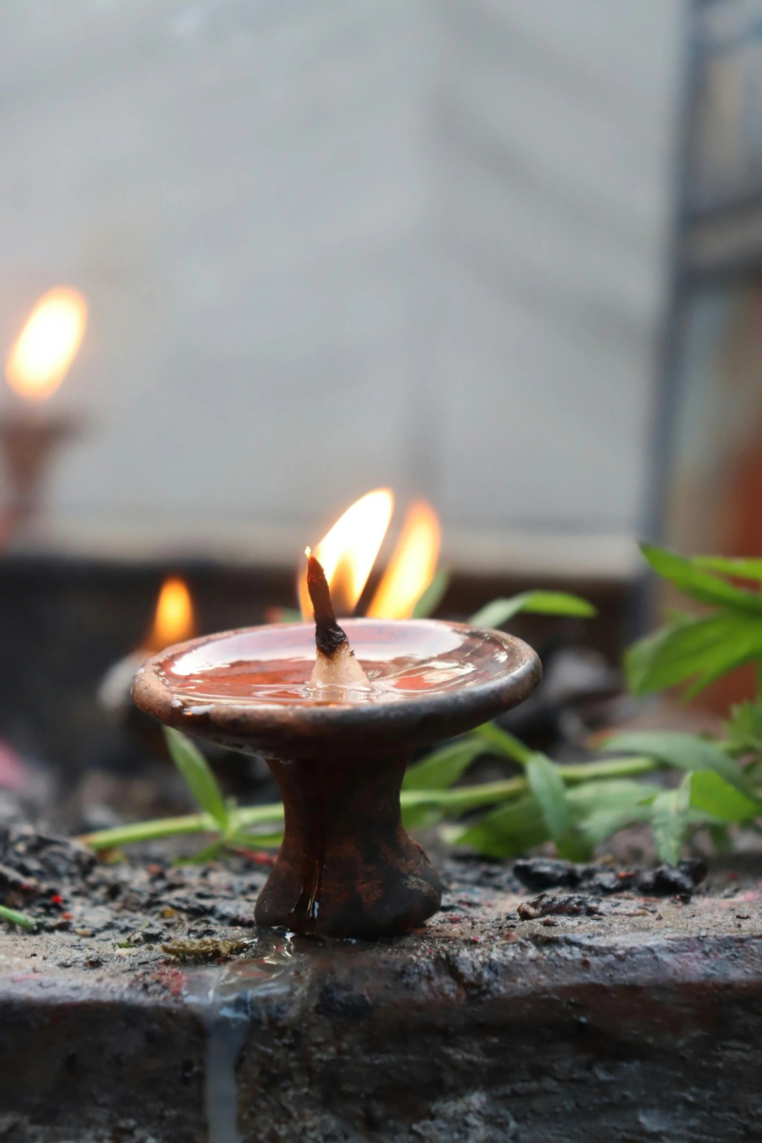 a group of candles sitting next to each other, incense, exterior shot, bronze, gardening
