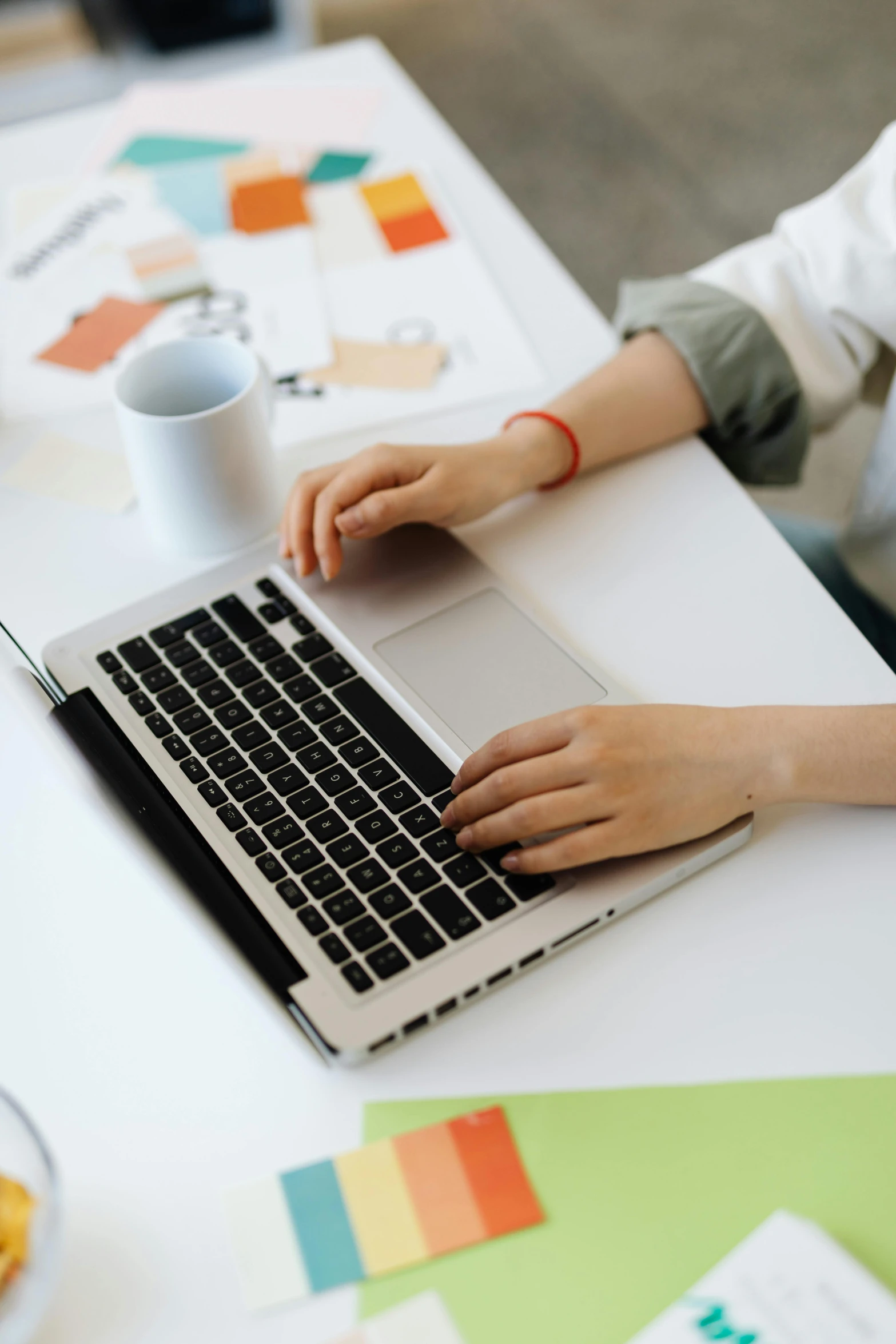 a woman sitting at a desk using a laptop computer, a computer rendering, pexels, multiple stories, low resolution, high angle shot, professional closeup photo