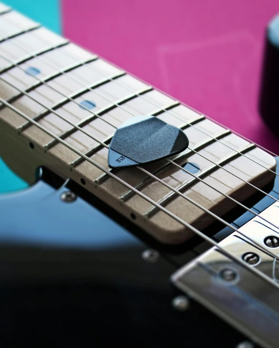 a close up of a guitar neck with a guitar pick, pexels contest winner, 3d printed, hexagonal shaped, non-binary, product introduction photo