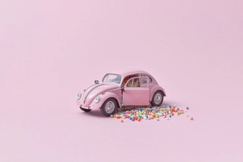 a pink toy car sitting on top of a pile of confetti, inspired by Chris LaBrooy, photorealism, jellybeans, beetle, society 6, color ( sony a 7 r iv