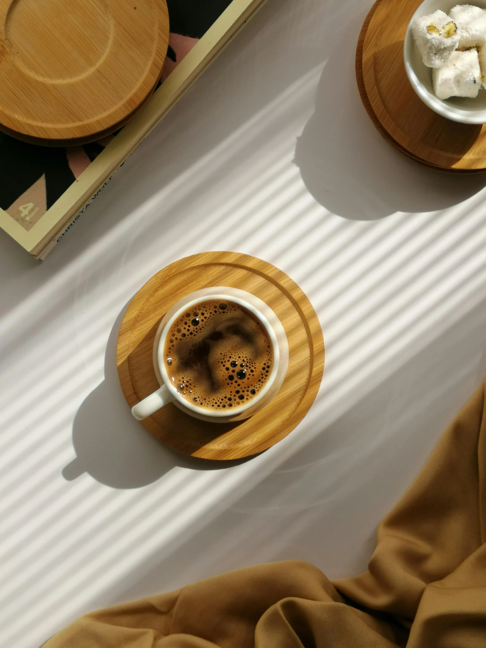 a cup of coffee sitting on top of a wooden tray, inspired by Muggur, sumatraism, bamboo wood, thin porcelain, trending on vsco, multiple stories