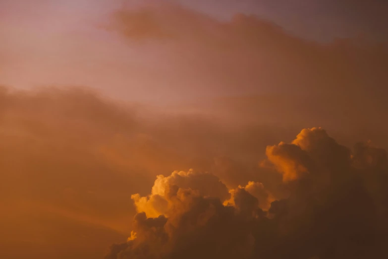 a large jetliner flying through a cloudy sky, by Daniel Seghers, pexels contest winner, romanticism, toned orange and pastel pink, humid evening, cumulus, gradient orange