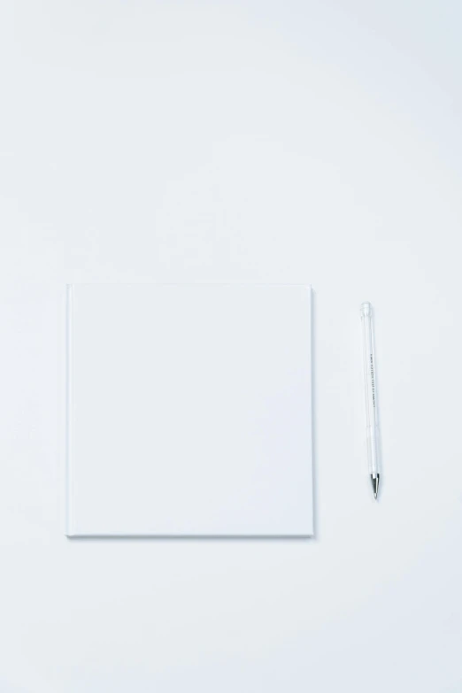 a piece of paper sitting on top of a table next to a pen, a picture, inspired by Agnes Martin, unsplash, postminimalism, pure white background, 144x144 canvas, art set, productphoto