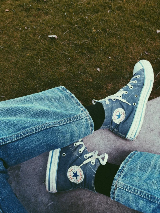 a person sitting on top of a skateboard, inspired by Elsa Bleda, trending on pexels, aestheticism, blue jeans and grey sneakers, standing in a grassy field, grainy low quality photograph, avatar image