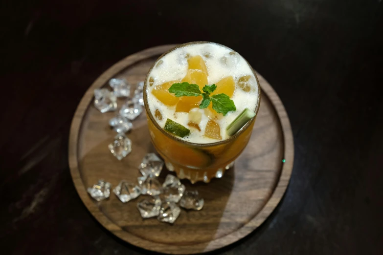 a drink sitting on top of a wooden plate, mango, profile image, dessert, bangalore