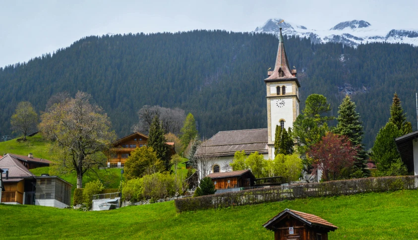 a small church sitting on top of a lush green hillside, by Sebastian Spreng, pexels contest winner, renaissance, swiss modernizm, village square, lead - covered spire, 9 9 designs