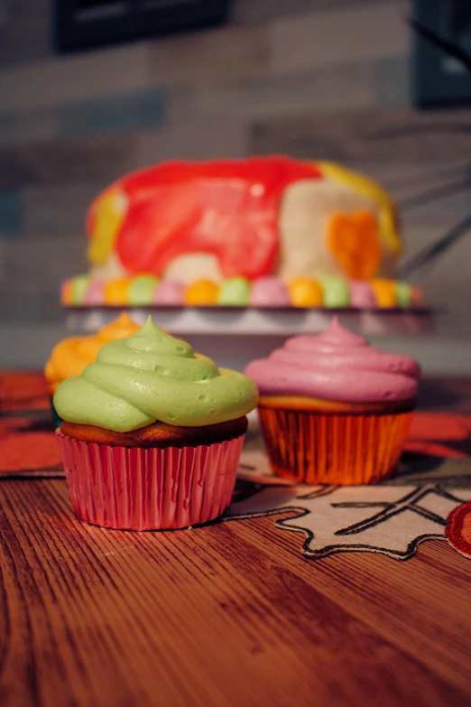 a couple of cupcakes sitting on top of a wooden table, a colorized photo, inspired by Peter Max, pexels, photorealism, 🍂 cute, made of candy, medium detail, desserts