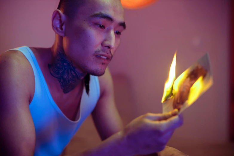 a man holding a lit match in his hand, a portrait, inspired by Liam Wong, trending on pexels, hyperrealism, 8 0 s asian neon movie still, bedroom full of fire, looking at his phone, bisexual lighting