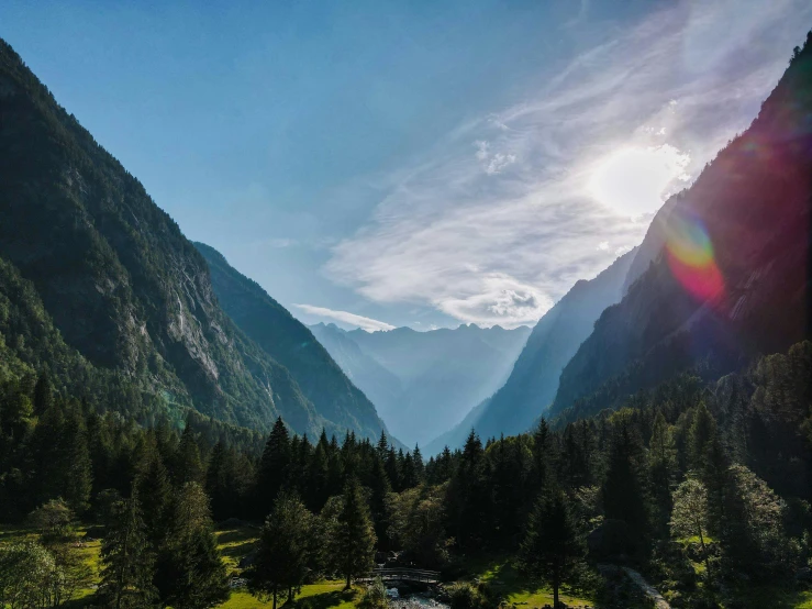 a river running through a lush green valley, by Sebastian Spreng, pexels contest winner, sunshine lighting high mountains, overlooking a valley with trees, chamonix, profile picture 1024px