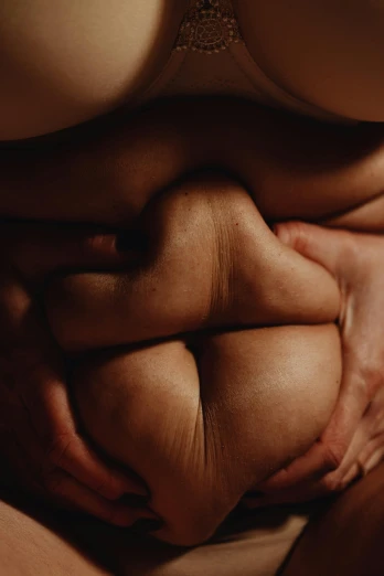 a naked woman sitting on top of a bed, an album cover, inspired by Hans Bellmer, unsplash, holding each other hands, muscular men entwined together, bottom body close up, spherical body