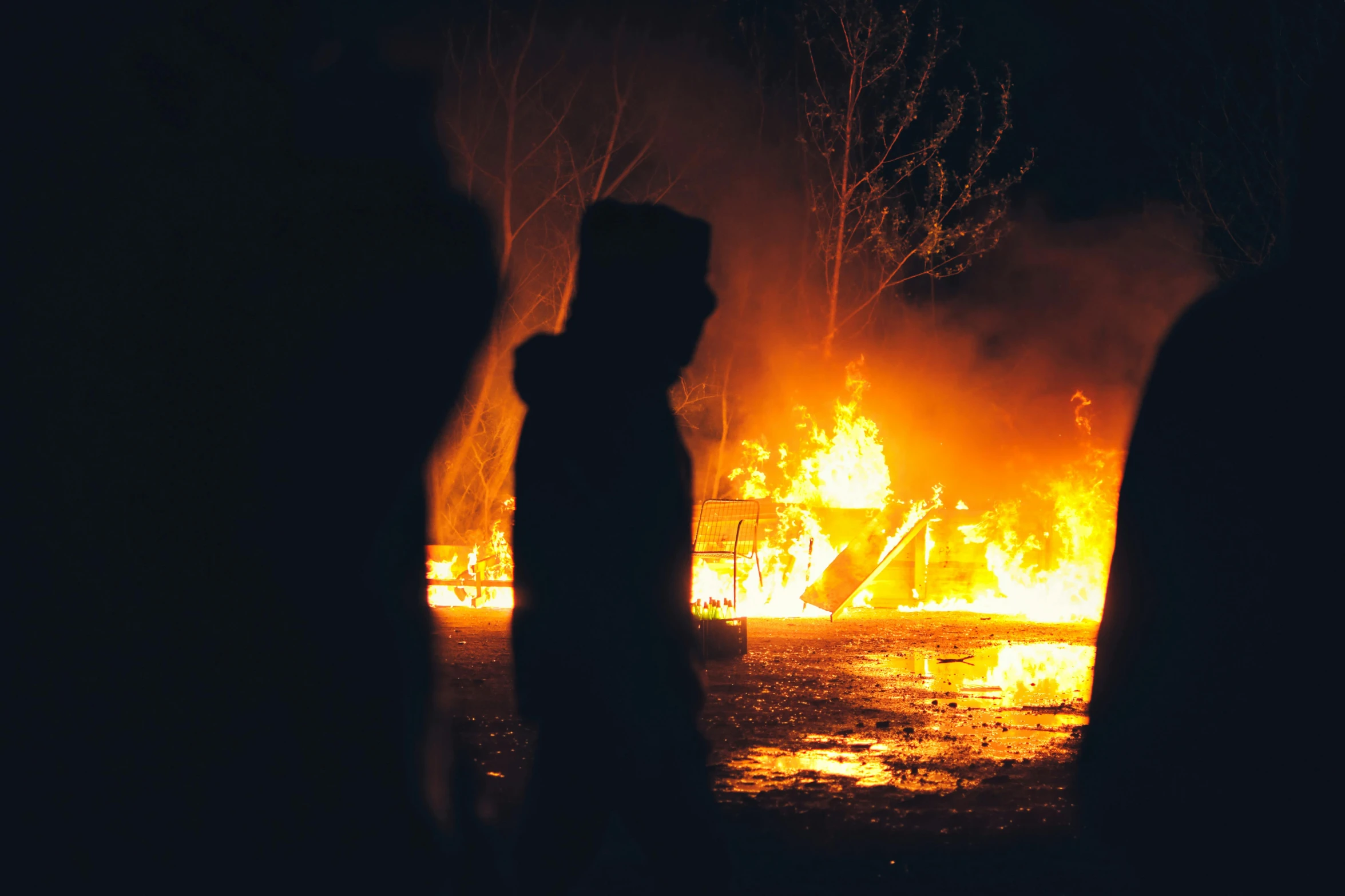 a group of people standing in front of a fire, at night, vandalism, profile image, eerie person silhouette