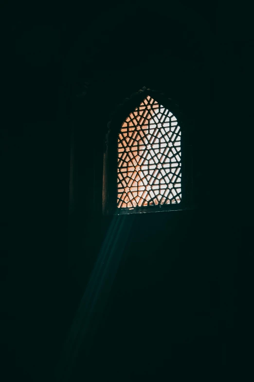 a light shining through a window in a dark room, hurufiyya, in front of a carved screen, ✨🕌🌙, unsplash photo contest winner, taken in the late 2000s