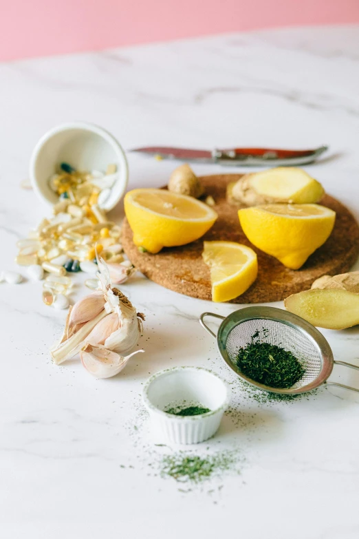 a wooden cutting board topped with lemon slices, botanicals, salt shaker, nina masic, soup