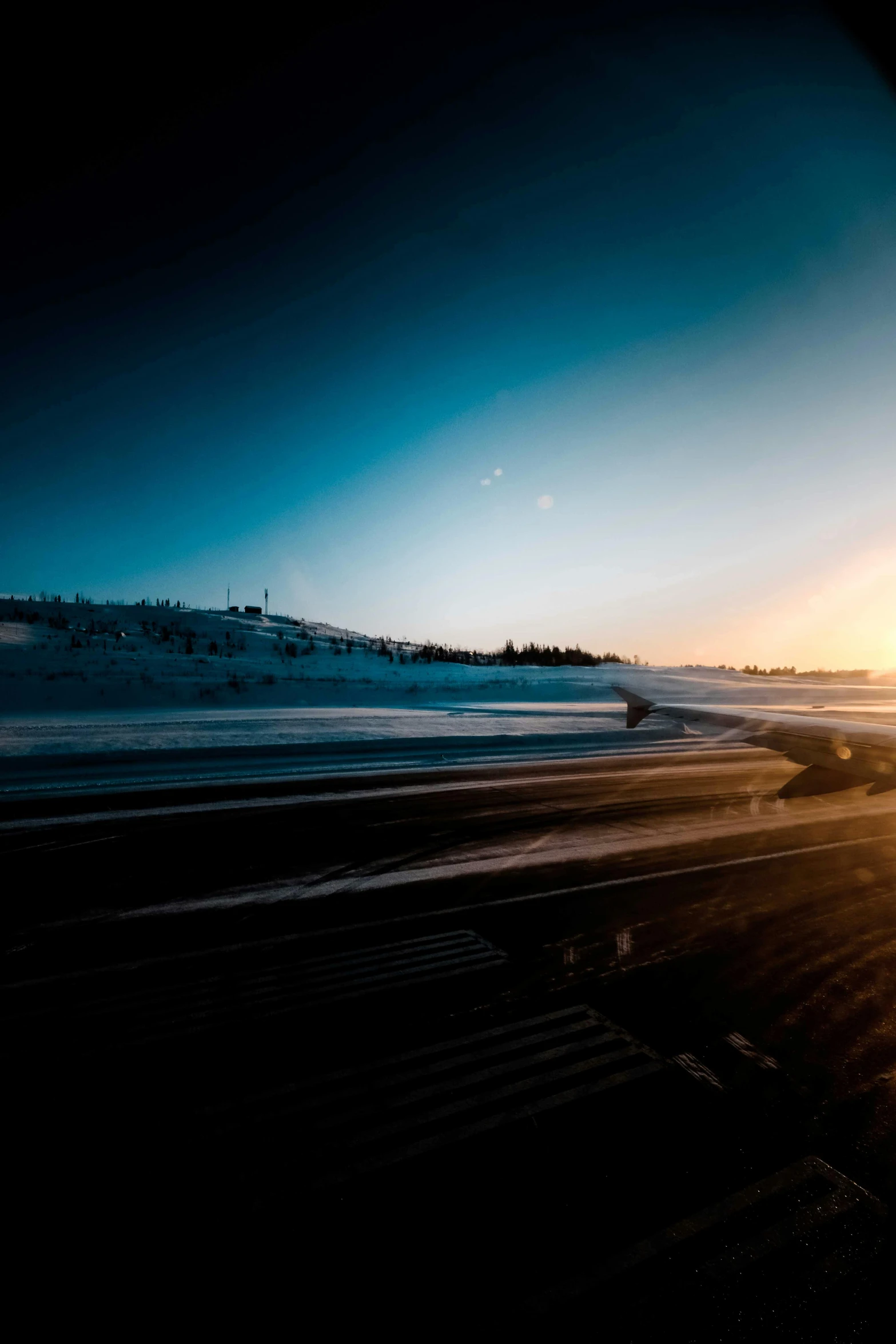 a man riding a snowboard on top of a snow covered slope, by Tobias Stimmer, pexels contest winner, hurufiyya, highway and sunset!!, at takeoff, desolate arctic landscape, car shot