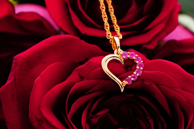 a red rose with a gold heart pendant on it, by Julia Pishtar, rubies, pink hearts in the background, product photography, thumbnail