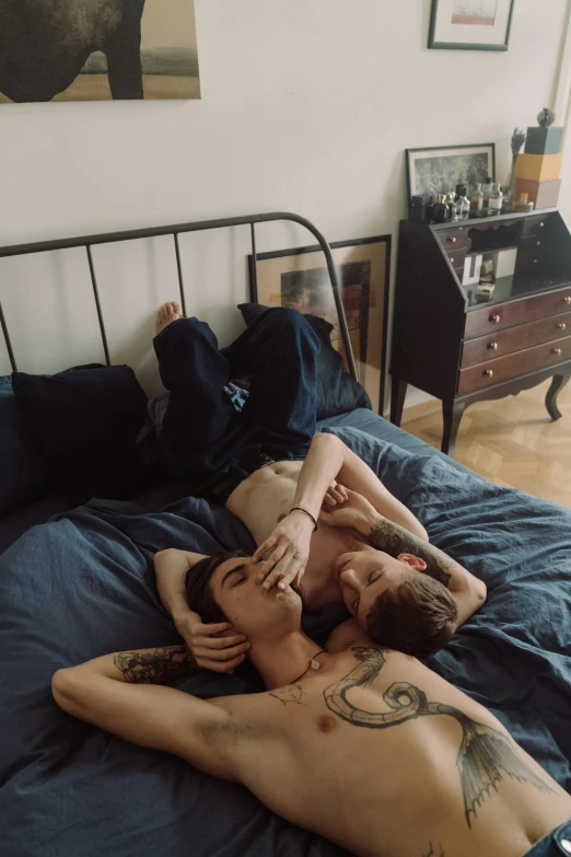 a couple of men laying on top of a bed, a photo, by Elsa Bleda, reddit, tattooed, greg rutkowski and jakub rebelka, cai xukun, neighborhood