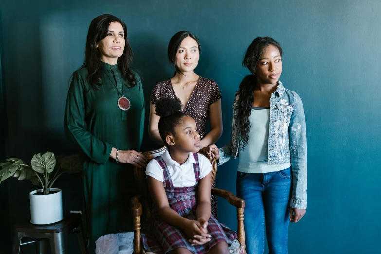 a group of women standing next to each other, a portrait, by Alison Geissler, scene from live action movie, mixed race, portait image, standing in corner of room