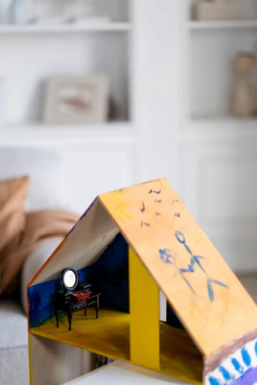 a doll house sitting on top of a table, a child's drawing, in the styles of joan miro, angled shot, hero shot, detail shot