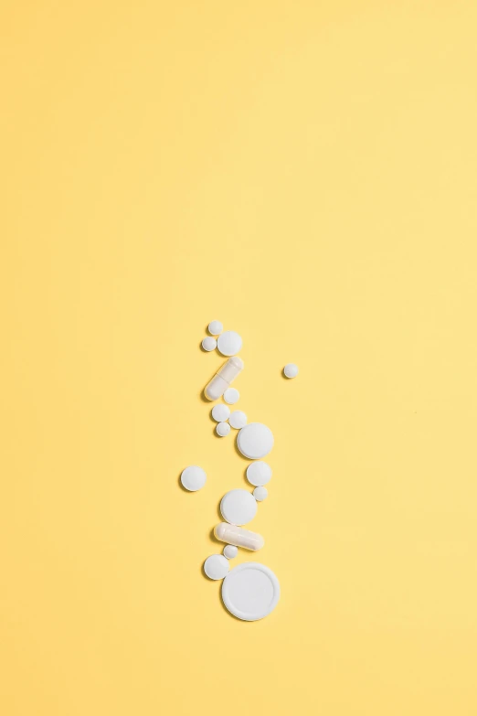 pills on a yellow background, by artist, unsplash, conceptual art, white in color, jen atkin, abstract white fluid, back facing