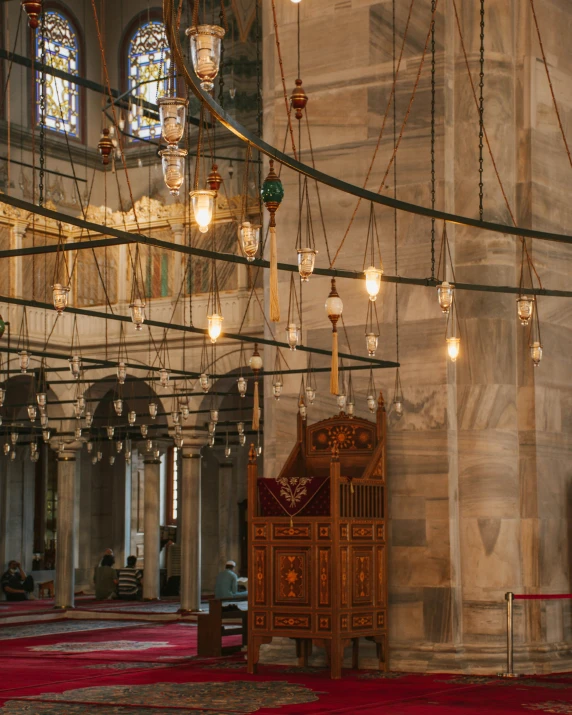 a large room with many chandeliers hanging from the ceiling, trending on unsplash, arabesque, mosque, hanging cables, overlooking, byzantine