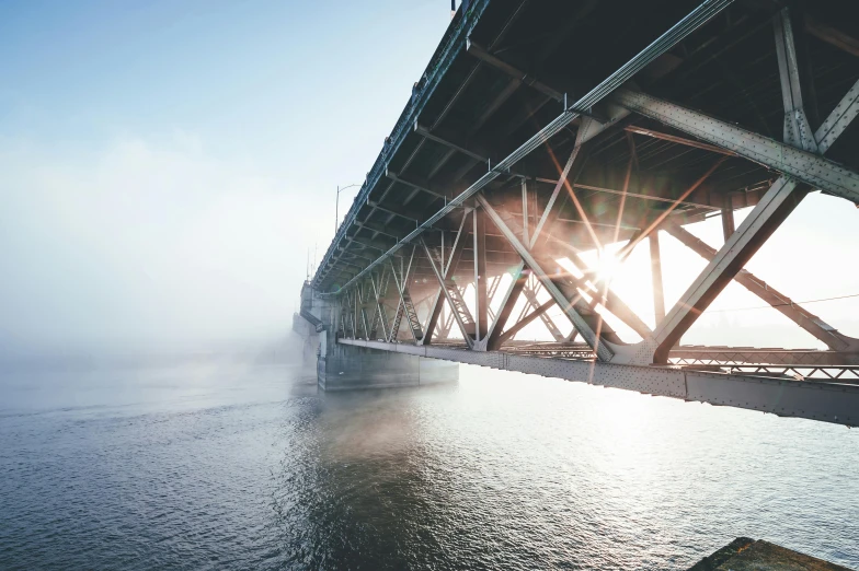 a bridge over a body of water on a foggy day, by Niko Henrichon, unsplash contest winner, 2 5 6 x 2 5 6 pixels, underbody, into bright light, hyperdetailed photo