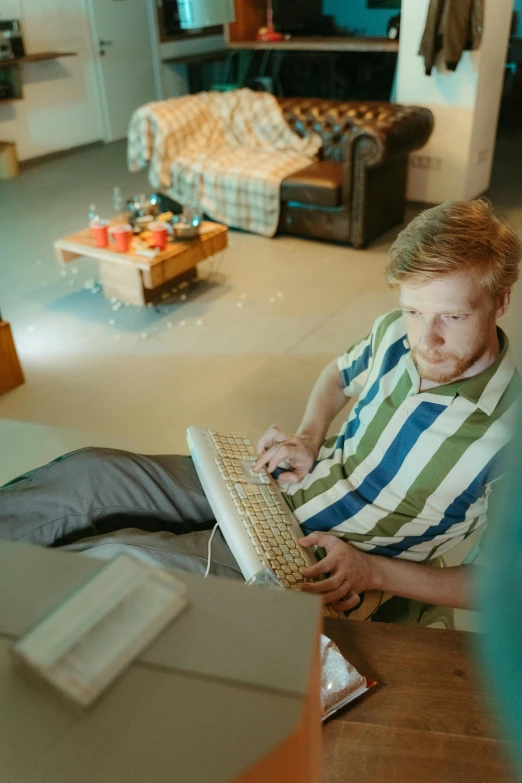 a man sitting on the floor using a laptop computer, inspired by mads berg, trending on pexels, video game still, hr ginger, loving stare, low quality photo