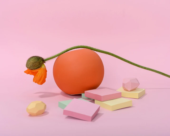 an orange egg sitting on top of a pink surface, an abstract sculpture, pexels contest winner, surrounded flower, poppy, rendered in 4 k, dimmed pastel colours