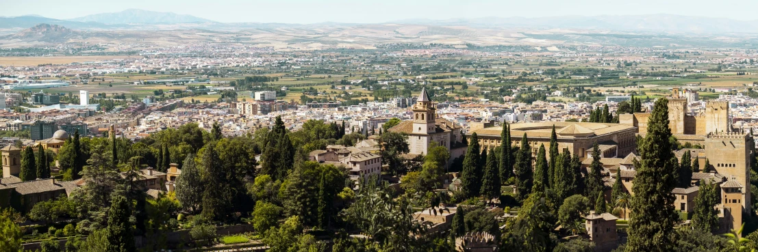 a view of a city from the top of a hill, inspired by Serafino De Tivoli, pexels contest winner, renaissance, seville, overlooking a valley with trees, “ aerial view of a mountain, moorish architecture
