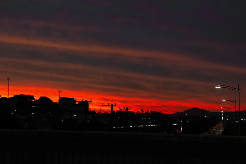 a red sky over a city at night, a picture, pexels contest winner, hurufiyya, sunset kanagawa prefecture, gradient red to black, ((sunset)), sun down