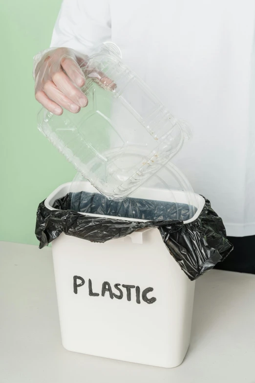 a person putting plastic in a trash can, an album cover, by Andries Stock, shutterstock, plasticien, 15081959 21121991 01012000 4k, synthetic bio skin, translucent, vessels