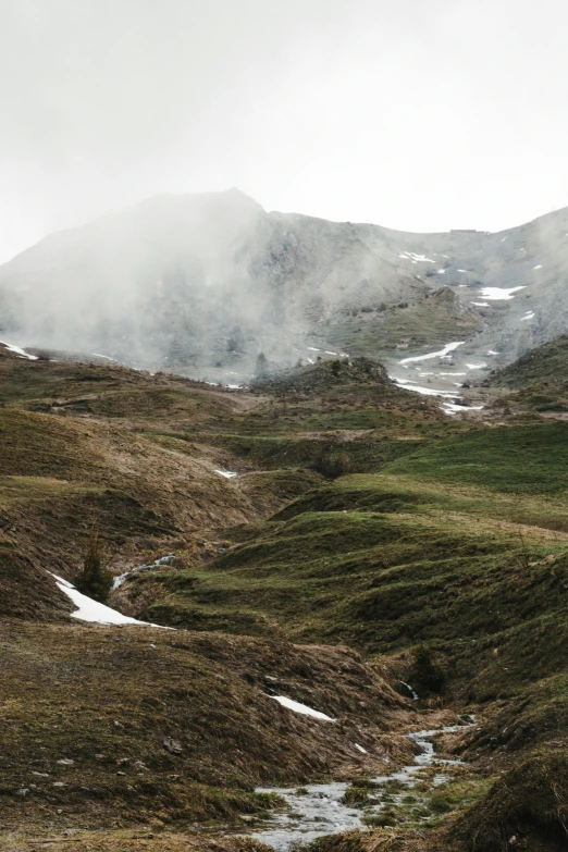a small stream running through a lush green valley, by Daniel Seghers, unsplash contest winner, les nabis, geysers of steam, sparse frozen landscape, panorama view, alps