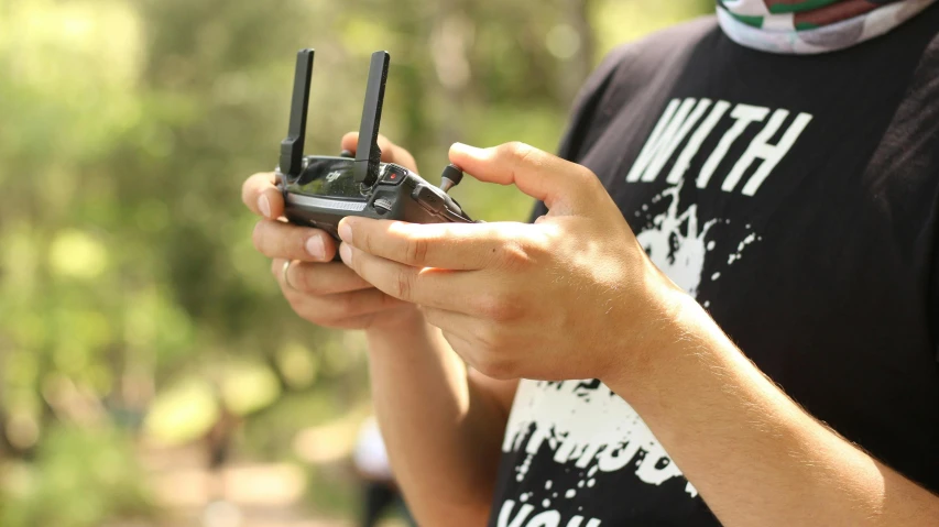 a close up of a person holding two cell phones, uav, 15081959 21121991 01012000 4k, mini model, student