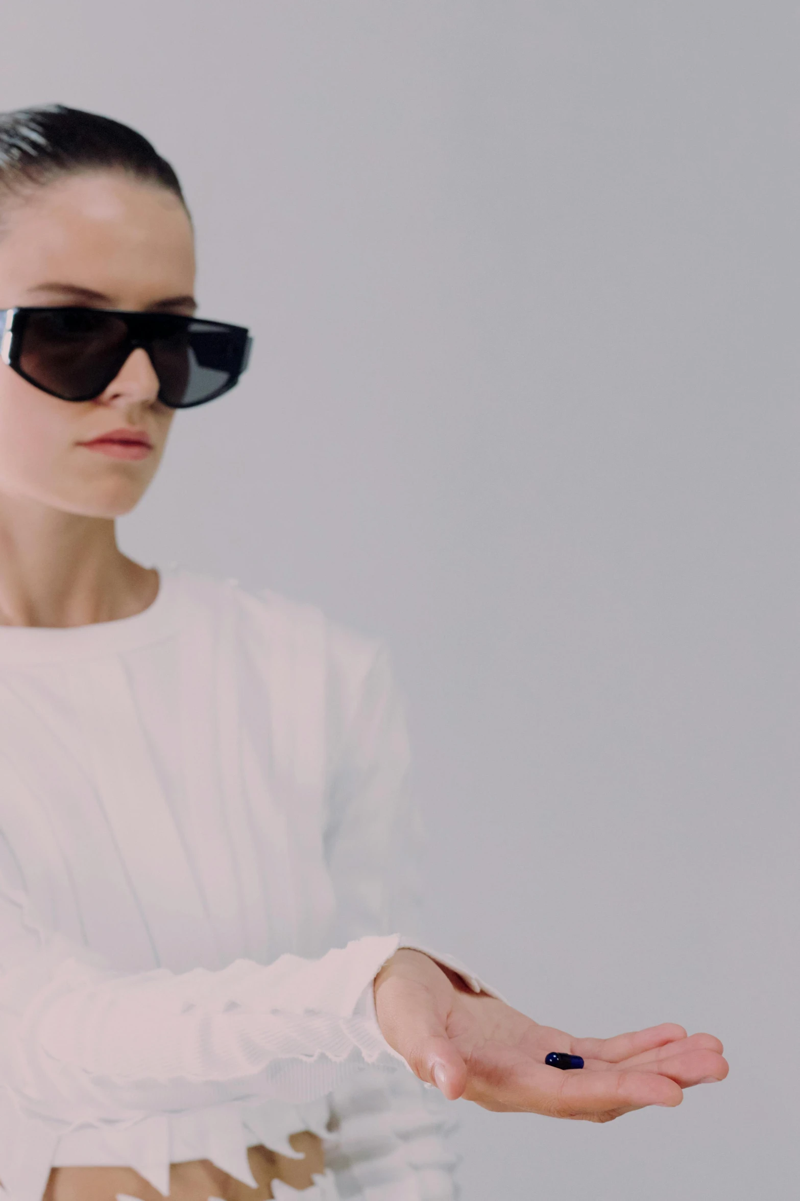 a woman in a white sweater and black sunglasses, inspired by Wang E, purism, supremely digital, arcadia, zoomed in, minimal clothing