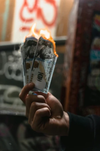 a person holding a bunch of money in their hand, an album cover, by Niko Henrichon, pexels contest winner, glowing fire, jordan lamarre - wan, reza afshar, magic shop