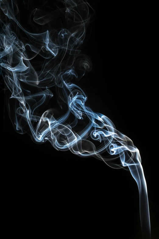a cigarette with smoke coming out of it, by Paul Davis, pexels, process art, wispy tendrils of smoke, blue haze, incense, high quality photo