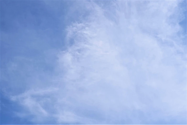 a man riding a snowboard on top of a snow covered slope, an album cover, unsplash, minimalism, wispy clouds in a blue sky, sky mural on the room ceiling, cloudless-crear-sky, cloud nebula