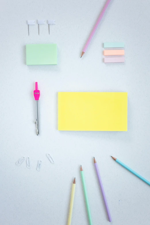 a white table topped with lots of different colored pencils, neon pastel color palette, notes, product shot, multiple stories