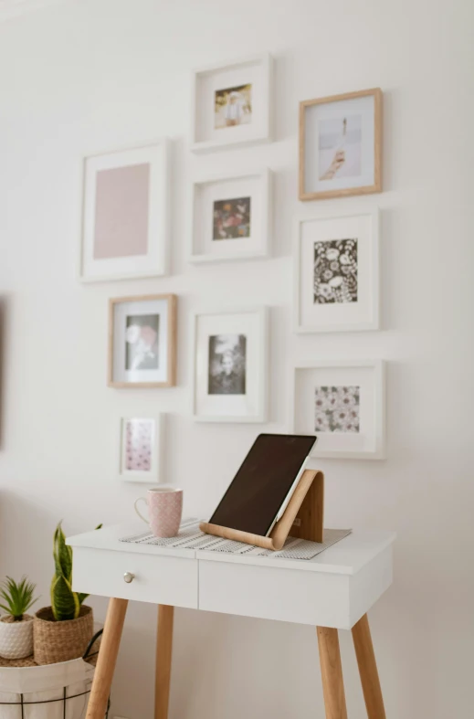 a white desk with a laptop on top of it, poster art, trending on unsplash, square pictureframes, small bedroom, dwell, willowy frame