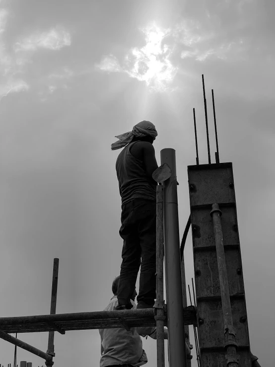 a black and white photo of a construction worker, by Joze Ciuha, pexels contest winner, blocking the sun, sayem reza, sky!!!, eyelevel!!! view!!! photography