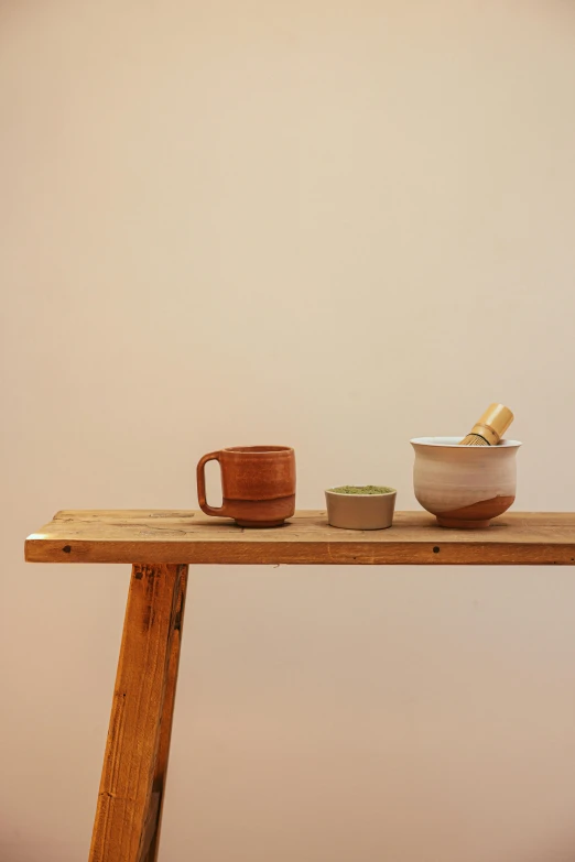 a wooden table topped with a bowl and a cup, a still life, unsplash, process art, collection product, square, made of glazed, bench