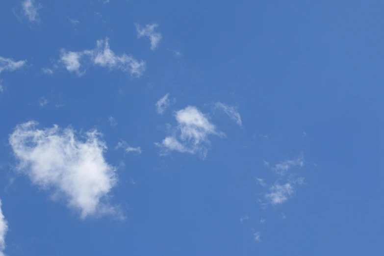 a large jetliner flying through a blue sky, inspired by Jan Rustem, minimalism, 15081959 21121991 01012000 4k, cotton clouds, a close-up, spores floating in the air