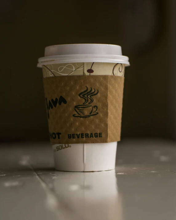 a cup of coffee sitting on top of a table, product image, detail shot, light tan, fully covered